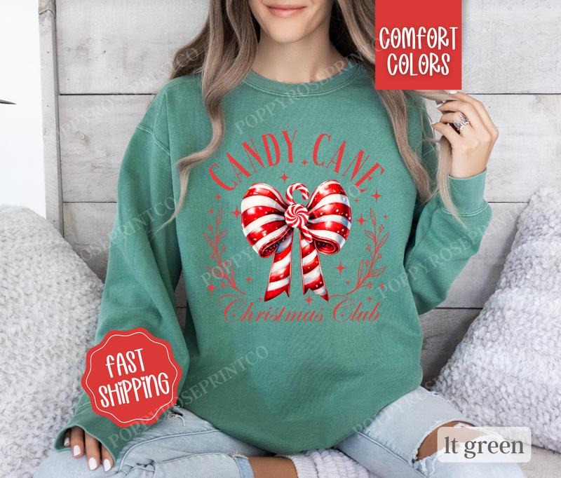 Candy Cane Christmas Club Comfort Colors Sweatshirt,  Coquette Christmas Sweater Womenswear,  Holiday Crewneck T-Shirts,...