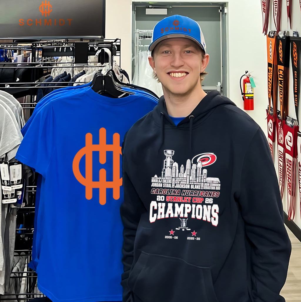 Carolina Hurricanes 2026 Stanley Cup Champions trophy alongside city skyline shirt