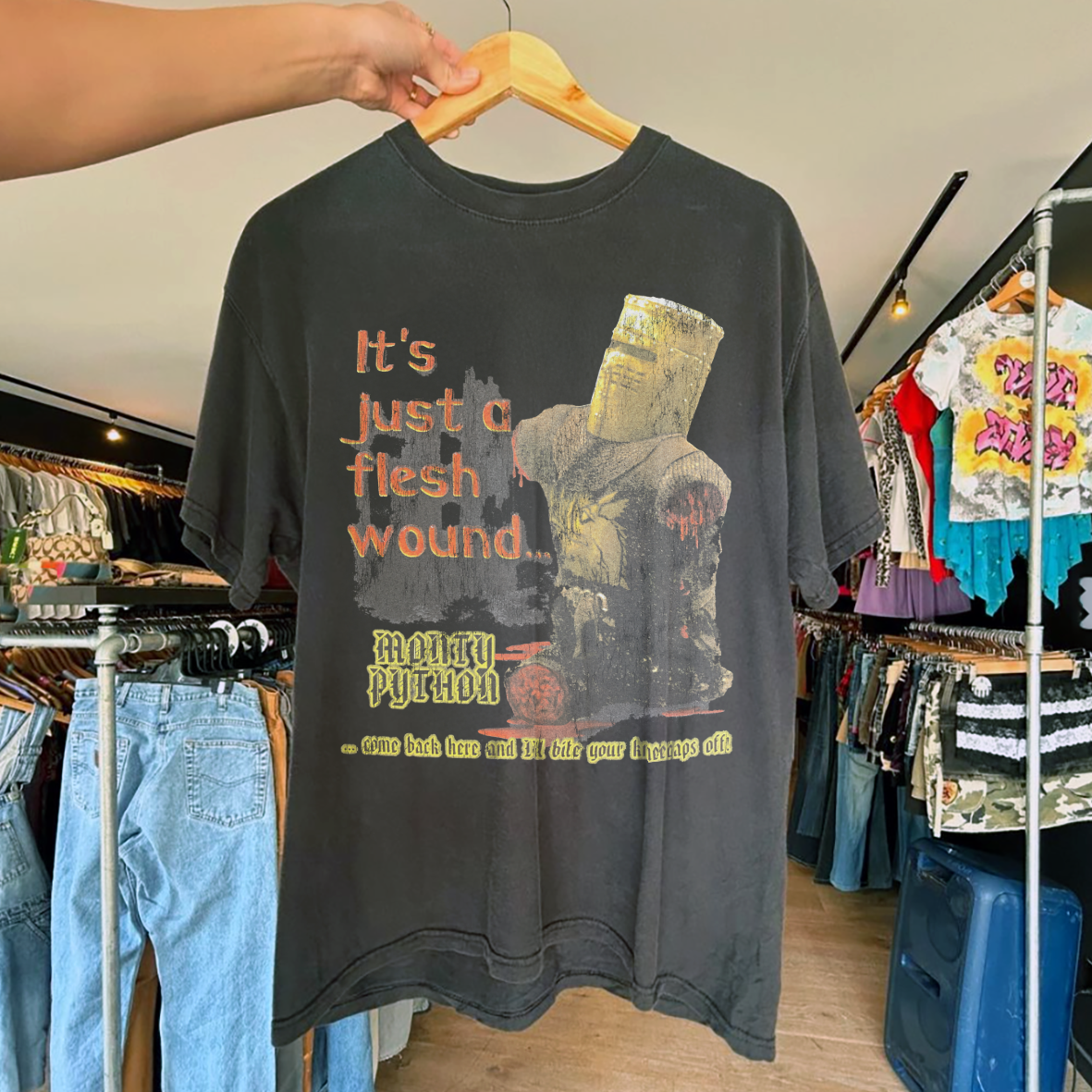 IT'S JUST A FLESH WOUND MONTY PYTH0NS 2001 PROMO VINTAGE WASHED BLACK T-SHIRT Hoodie, Sweatshirt | PureTeeCo.com (Image 1)