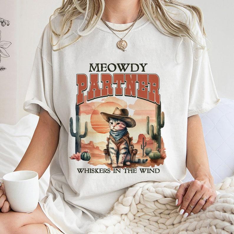 Meowdy Partner Whiskers In The Wind Shirt,Trending Unisex Tee Shirt Hoodie, Sweatshirt | PureTeeCo.com (Image 1)