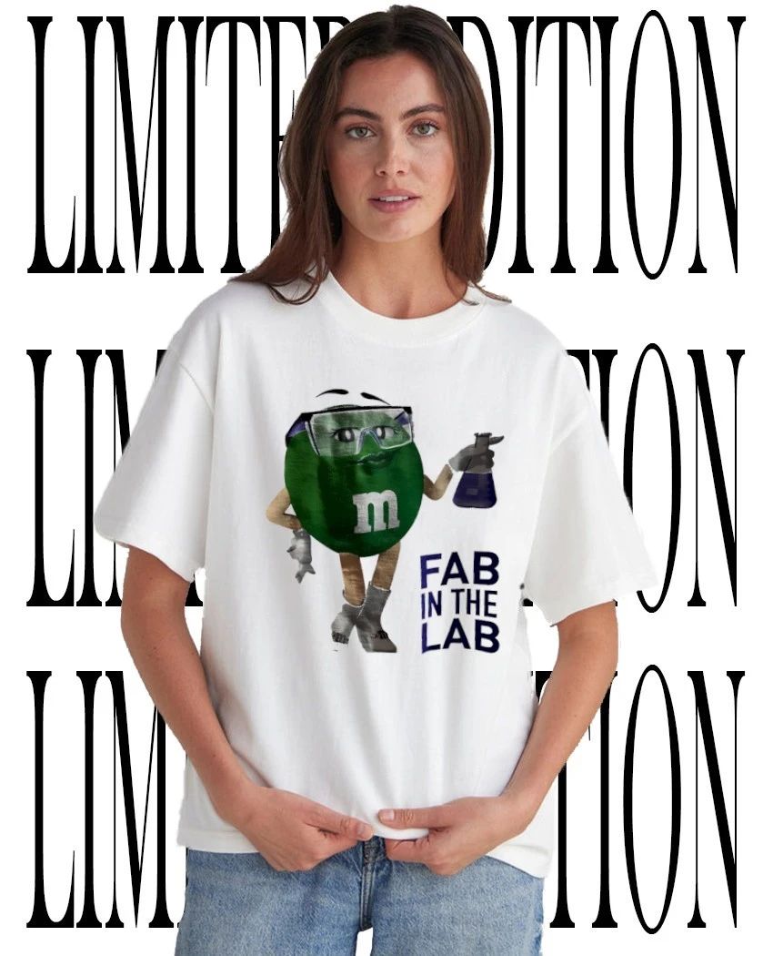 M and M’s Ms Green fab in the lab holding beaker wrench caricature shirt